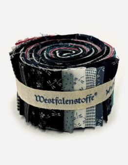 Rolled bundle of patchwork fabric strips in navy, cream, and blue tones bound with a beige ribbon-style band. Close-up of a fabric bolt showing layered quilt-like swatches rolled together and tied with a light beige strap. Assorted fabric samples rolled into a coil, featuring dark and light patterns in blue, black, and red hues. A tightly wound stack of fabric strips forming a circular roll, bound by a woven beige belt with printed text accents. Close-up of a fabric roll used for quilting projects, displaying various printed patterns bound by a neutral strap.