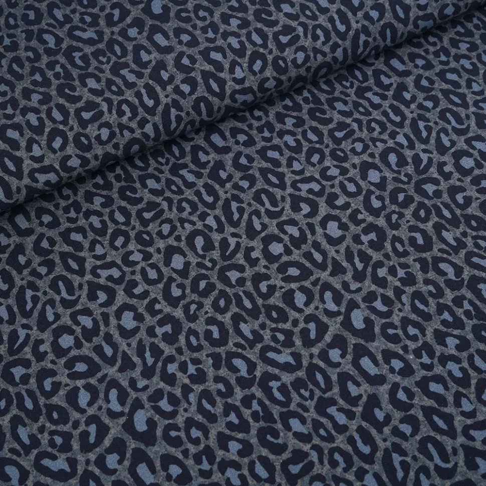 Close-up of dark blue-gray leopard print fabric with a rolled edge at the top-left corner.